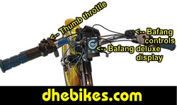 Custom made to order Womens electric downhill mountain bike by Pinnacle Innovations cockpit view showing the GripShift shifters, high rise bar and the Bafang 750 Watt mid mount electric motor throttle.
